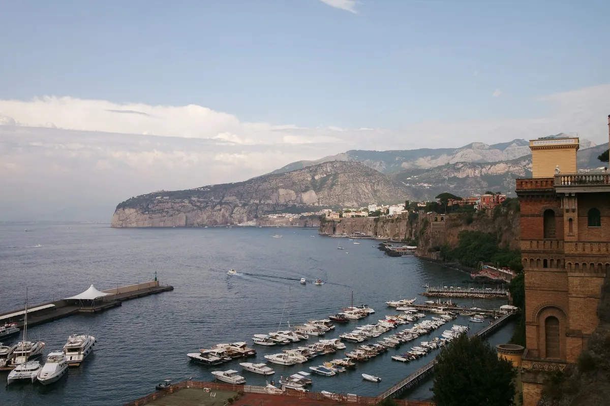 Vista aérea da Marina Grande e do porto de Sorrento com prédios históricos à beira-mar