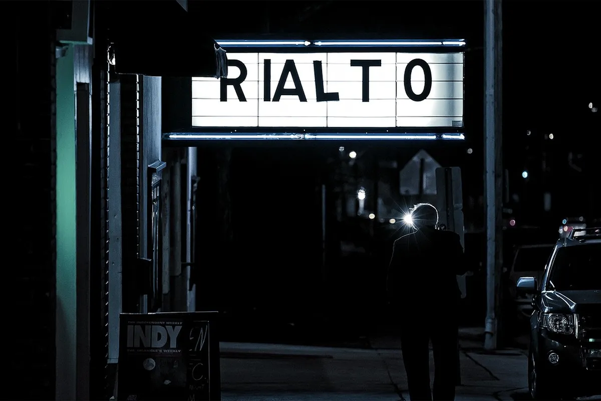 Fachada de cinema iluminada à noite