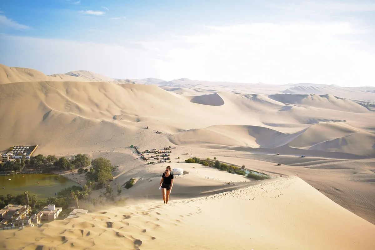 Viajante caminhando nas dunas de Huacachina em Ica