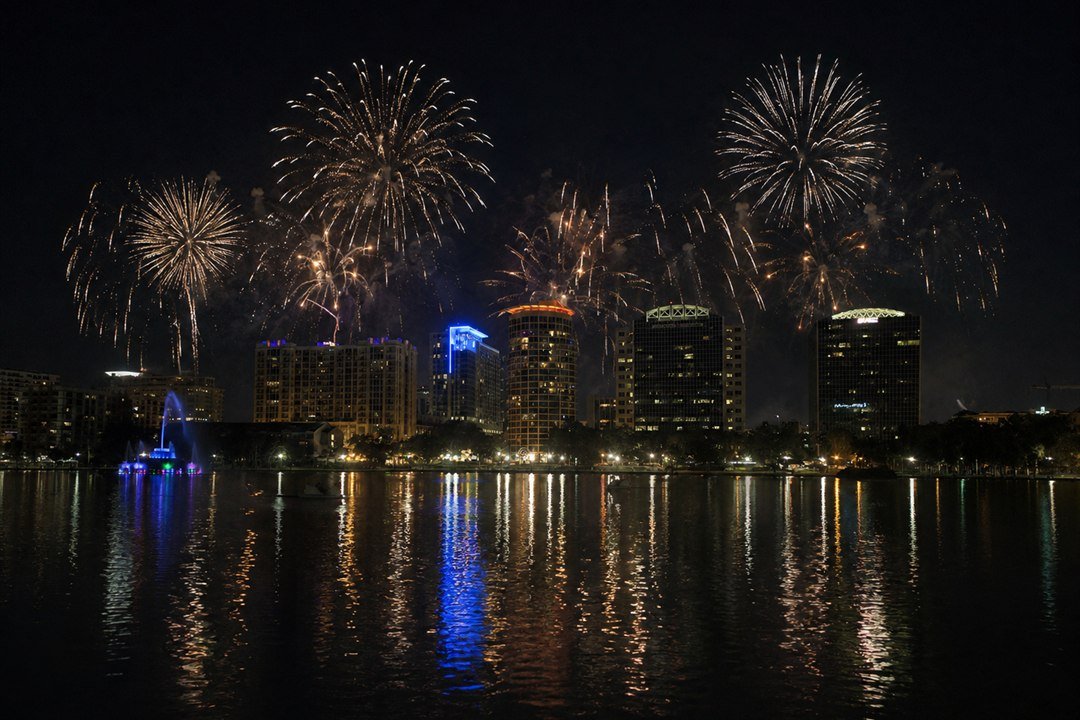 Imagem editorial de fogos sobre o Lake Eola e o skyline de Orlando à noite